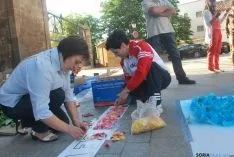 Los quintos del 65 preparan el tapiz floral para el Corpus Christi. / SN